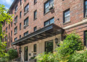 Thumbnail 2 of 41 - the front of a brick building with steps and plants