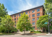 Thumbnail 1 of 41 - a large red brick building with trees in front of it