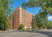 Thumbnail 3 of 34 - a large brick building on the corner of a city street