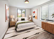 Thumbnail 7 of 27 - a bedroom with a bed and two windows