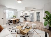 Thumbnail 5 of 27 - a living room and kitchen with white walls and wood flooring