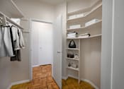Thumbnail 10 of 15 - A hallway with a white door and a white closet with a shelf and a black speaker.