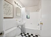 Thumbnail 21 of 27 - a white bathroom with a black and white checkered floor