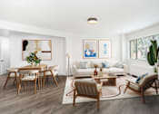 Thumbnail 5 of 7 - A living room with a white couch, wooden chairs, and a rug.