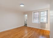 Thumbnail 6 of 35 - A room with a wooden floor and a window with blinds.