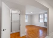 Thumbnail 8 of 35 - A room with wooden floors and white walls.