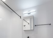 Thumbnail 11 of 35 - A white toilet sits next to a white bathtub in a bathroom.