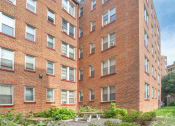 Thumbnail 2 of 16 - the courtyard of a brick building with a picnic table