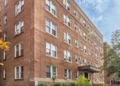 Thumbnail 1 of 16 - a large brick building with a sidewalk in front of it