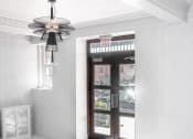 Thumbnail 7 of 41 - a view of a lobby with a door and a ceiling fan