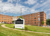 Thumbnail 1 of 7 - a large building with a sign in front of it