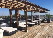 Thumbnail 4 of 34 - a rooftop deck with lounge chairs and a pergola