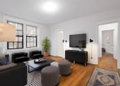 Thumbnail 19 of 41 - a living room with black furniture and a tv