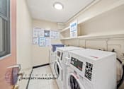 Thumbnail 10 of 17 - A laundry room with washers and dryers and a sign that says Beach Front Property Management.