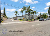 Thumbnail 28 of 32 - A street view with the logo of Beach Front Property Management.