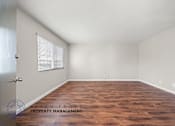 Thumbnail 14 of 32 - A room with wooden flooring and a window with blinds.