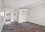 Thumbnail 10 of 18 - A room with a carpeted floor and white walls.