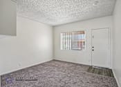 Thumbnail 3 of 18 - A room with a carpeted floor and a door.