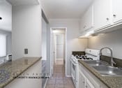 Thumbnail 6 of 17 - a kitchen with white cabinets and granite counter tops and a sink