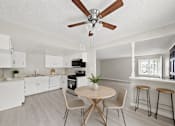 Thumbnail 2 of 6 - A kitchen with a table and chairs.