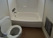 Thumbnail 6 of 6 - A white bathroom with a toilet, tub, and window.