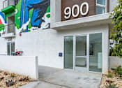 Thumbnail 14 of 33 - A building with a mural on the wall and a number 900 on the top.