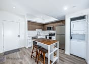 Thumbnail 20 of 33 - A kitchen with a wooden table and bar stools.
