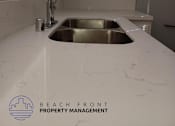 Thumbnail 3 of 10 - a white counter top with a sink in a kitchen