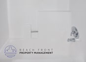 Thumbnail 10 of 10 - a white bathroom with a shower and a sink