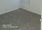 Thumbnail 6 of 10 - A room with a window covered by blinds.