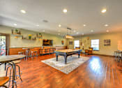 Thumbnail 20 of 40 - A large open room with wooden floors and a long table.