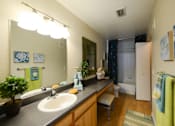 Thumbnail 34 of 40 - A bathroom with a sink, mirror, and towel rack.