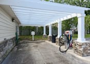 Thumbnail 35 of 40 - A gas station with a white canopy and a green hose.