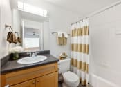 Thumbnail 29 of 41 - a bathroom with a shower and a sink and a toilet