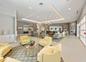 Thumbnail 24 of 44 - a large lobby with couches and chairs and a reception area