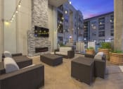 Thumbnail 15 of 22 - a patio with furniture and a fireplace in an apartment building