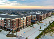 Thumbnail 1 of 23 - an aerial view of a large apartment building on a city street