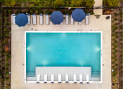 Thumbnail 4 of 23 - an aerial view of a pool with umbrellas and chairs around it