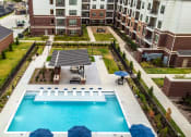 Thumbnail 2 of 23 - an aerial view of a swimming pool in front of an apartment building