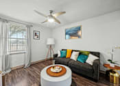 Thumbnail 5 of 36 - A living room with a grey couch and a wooden coffee table.