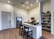 Thumbnail 17 of 23 - a kitchen with a large island with three stools