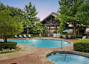 Thumbnail 12 of 28 - a swimming pool with a hotel in the background