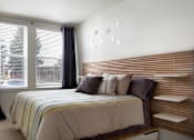 Thumbnail 7 of 16 - a bedroom with a bed and two windows