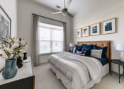 Thumbnail 20 of 23 - a bedroom with a bed and a ceiling fan