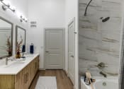 Thumbnail 23 of 23 - a bathroom with a shower and a sink and a mirror