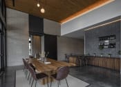 Thumbnail 14 of 22 - a large wooden table with chairs in a room with brick walls and a wooden ceiling