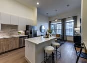 Thumbnail 18 of 23 - an open kitchen and living room with a large island and stools