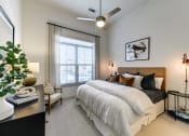 Thumbnail 19 of 23 - a bedroom with a large bed and a ceiling fan