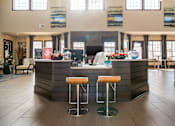 Thumbnail 14 of 29 - A reception area with a bar and two stools.
