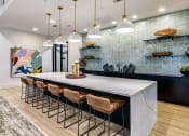 Thumbnail 16 of 23 - a large kitchen with a marble counter top and bar stools